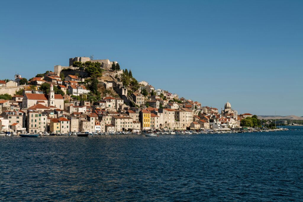 Beautiful coastal cityscape of Šibenik, Croatia with historic fortress and Adriatic Sea.